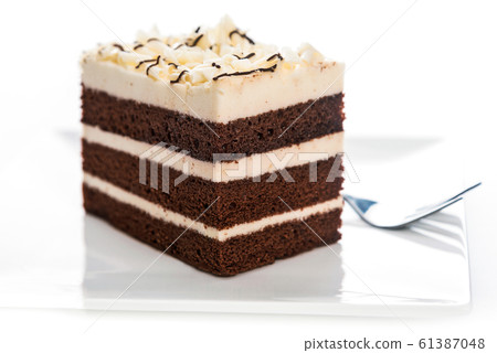 Piece of sponge cake on a plate 61387048