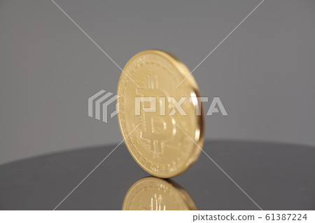 Golden Bitcoin coin on gray background Golden Bitcoin coin on gray background 61387224