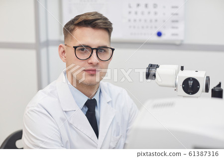 Young Opthalmologist Looking at Camera in Office 61387316