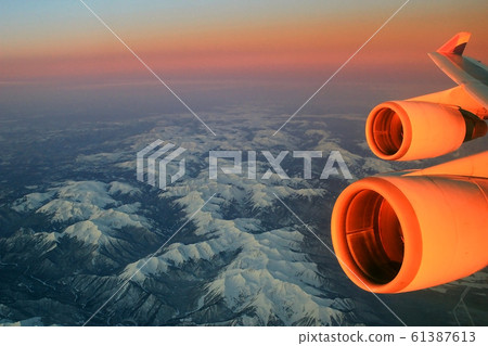Flight over Siberia during sunrise 61387613
