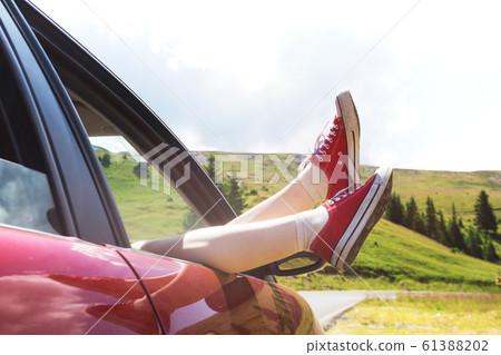 Girl legs sticking out of the car Girl legs sticking out of the car 61388202