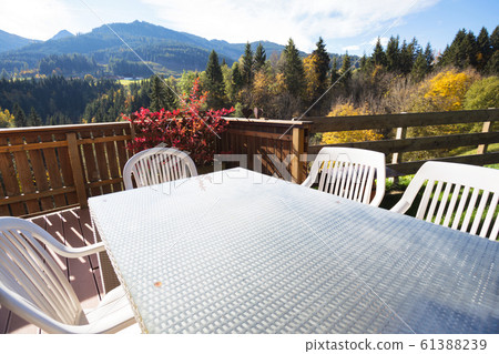 cozy terrace with a table and chairs cozy terrace with a table and chairs 61388239