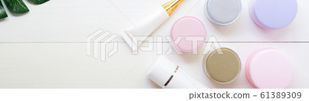 cosmetic and skin care product and green leaves on white wood table cosmetic and skin care product and green leaves on white wood table 61389309