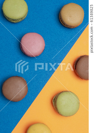 Colorful macaroons over a colored bakcground 61389825