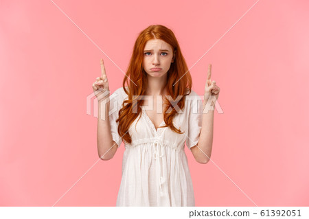 Silly upset, timid and insecure pouting redhead girl, looking camera gloomy with sulking whining expression, pointing fingers up with regret or jealousy, asking for something, begging hopeful Silly upset, timid and insecure pouting redhead girl, looking camera gloomy with sulking whining expression, pointing fingers up with regret or jealousy, asking for something, begging hopeful 61392051