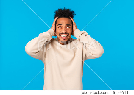 Distressed and tensed young african american male student suffering huge mental breakdown, headache, squeeze head with hands on temples, clench teeth troubled, feel panic and uneasiness 61395113