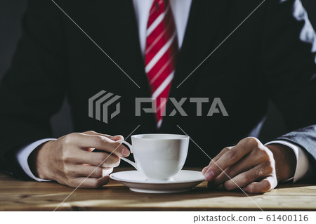 Businessman drinking coffee Businessman drinking coffee 61400116