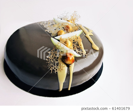 Apple and caramel nutty chocolate cake on white background 61401679