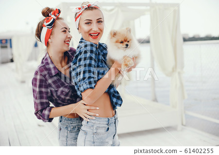 Stylish pin up girls with the little dog Stylish pin up girls with the little dog 61402255