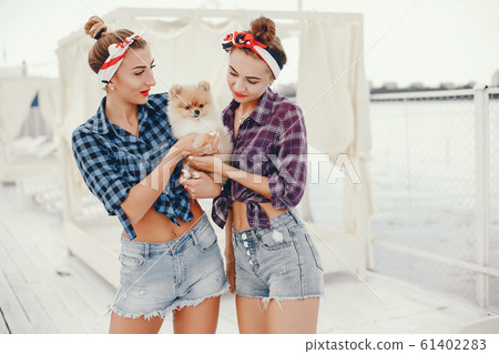 Stylish pin up girls with the little dog 61402283