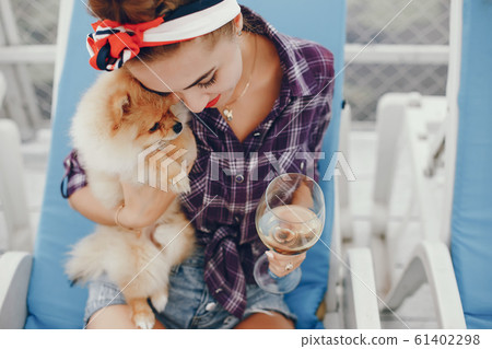 Stylish pin up girl with the little dog 61402298