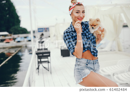 Stylish pin up girl with the little dog 61402484