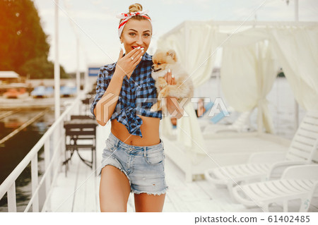 Stylish pin up girl with the little dog Stylish pin up girl with the little dog 61402485