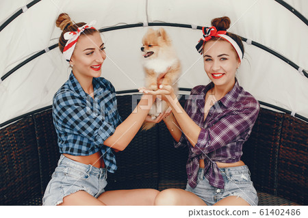 Stylish pin up girls with the little dog 61402486