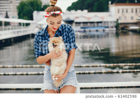 Stylish pin up girl with the little dog Stylish pin up girl with the little dog 61402598