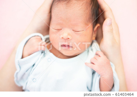 Newborn baby boy sleeping by mom Newborn baby boy sleeping by mom 61403464