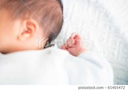 Newborn baby boy sleeping in bed Newborn baby boy sleeping in bed 61403472