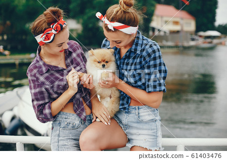 Stylish pin up girls with the little dog Stylish pin up girls with the little dog 61403476