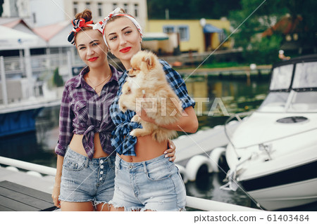 Stylish pin up girls with the little dog 61403484