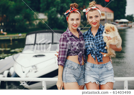 Stylish pin up girls with the little dog Stylish pin up girls with the little dog 61403499