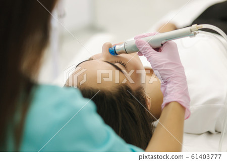 First-person view of cosmetologist doing beauty procedure at cosmetology clinic 61403777