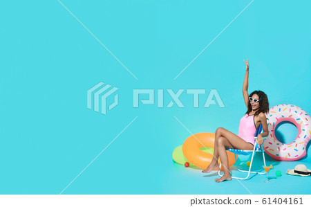 woman dressed in swimwear gesturing say hi woman dressed in swimwear gesturing say hi 61404161