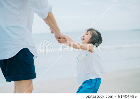 Family enjoying a sea bath 61404489