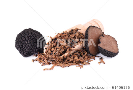Grated Truffle on a wooden spoon. Fresh black truffles isolated on a white background. Delicacy exclusive truffle mushroom. Piquant and fragrant French delicacy. Clipping path. 61406156