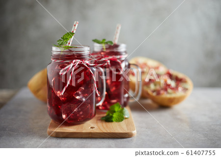 Pomegranate juice in jar with handle. . Pomegranate juice in jar with handle. . 61407755