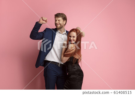 Valentine's day celebration, happy caucasian couple isolated on coral background Valentine's day celebration, happy caucasian couple isolated on coral background 61408515