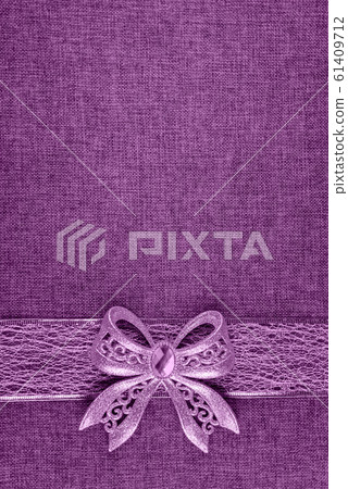 Lilac bow and ribbon on burlap. Vertical image. Lilac bow and ribbon on burlap. Vertical image. 61409712