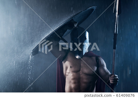 Spartan hiding from rain with shield. Spartan hiding from rain with shield. 61409876