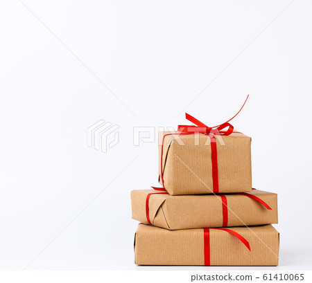 stack of gifts in boxes wrapped in brown kraft stack of gifts in boxes wrapped in brown kraft 61410065