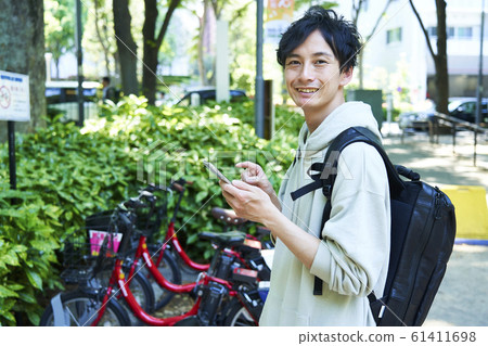 Young man riding a bicycle in the city 61411698