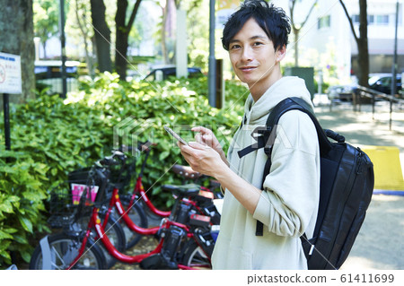 Young man riding a bicycle in the city 61411699