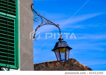 Street lighting concept, lamp, candlestick on blue 61412205