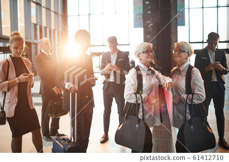 People waiting for their queue at the airport People waiting for their queue at the airport 61412710