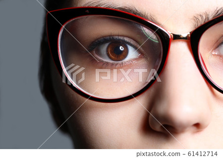 Close-up view of female right eye wearing glasses Close-up view of female right eye wearing glasses 61412714