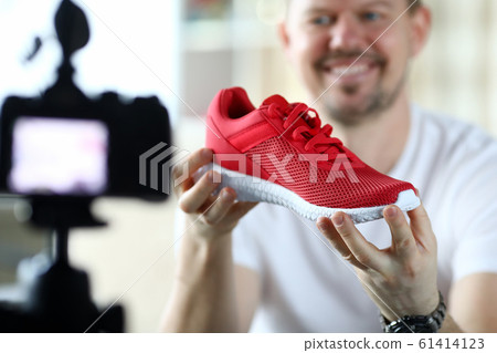 Male product reviewer tells his subscription in an online 61414123
