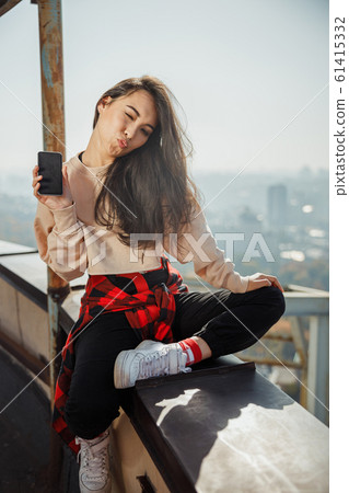 Happy pretty girl winking at the camera 61415332