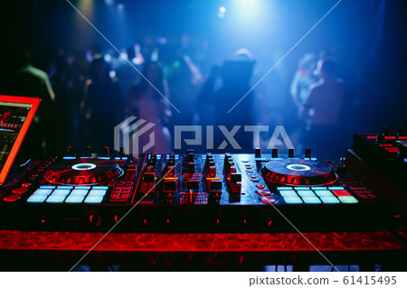 DJ mixer controller at a party in a nightclub 61415495