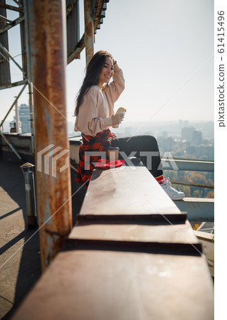 Happy pretty lady having lunch on the roof Happy pretty lady having lunch on the roof 61415496