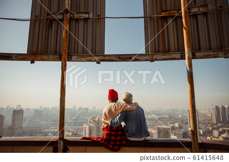 Young guy and girl hugging on the roof Young guy and girl hugging on the roof 61415648