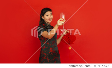 Happy Chinese New Year. Asian young girls's portrait isolated on red background Happy Chinese New Year. Asian young girls's portrait isolated on red background 61415878