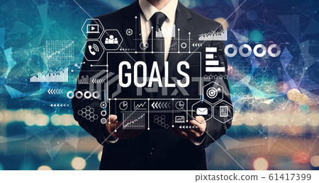 Goal concept with businessman holding a tablet Goal concept with businessman holding a tablet 61417399