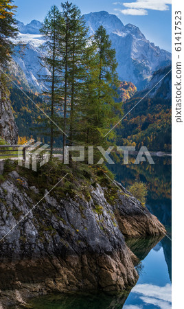 Peaceful autumn Alps mountain lake with clear Peaceful autumn Alps mountain lake with clear 61417523