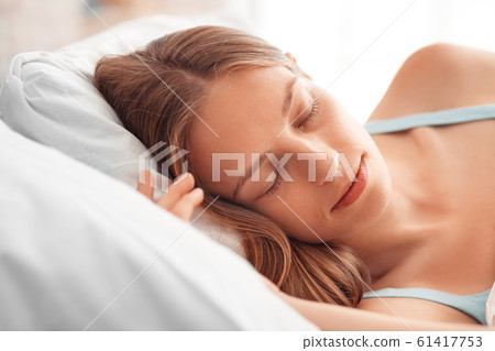 Morning at Home. Woman lying on bed sleeping peaceful face close-up Morning at Home. Woman lying on bed sleeping peaceful face close-up 61417753