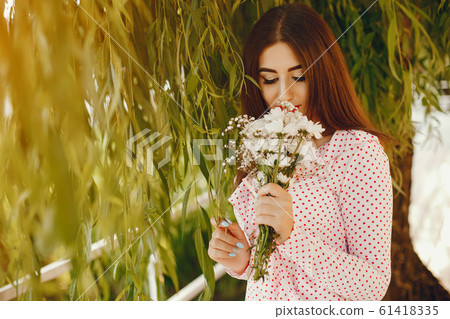 Cute girl walking in a summer park 61418335