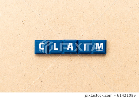 Tile letter in word claim on wood background Tile letter in word claim on wood background 61421089