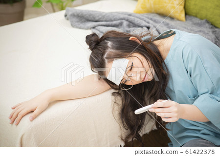 Woman cold fever influenza poor health thermometer 61422378